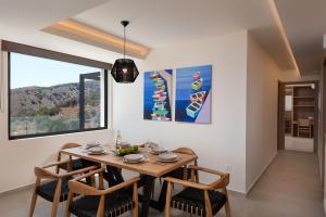 a dining room with a wooden table and chairs at Villa Cristina in Elounda