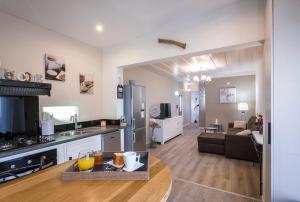 a large living room with a kitchen and a living room at Le Grand Badamier Blanc grande villa familiale 5 étoiles piscine chauffée 17 personnes in Saint-Paul