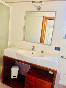 a bathroom with a sink and a mirror at Residenza La Rotonda in Vasto +6 photos
