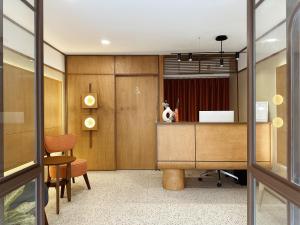an office with a reception desk and a table at Parcel Hotel Bangkok in Bangkok