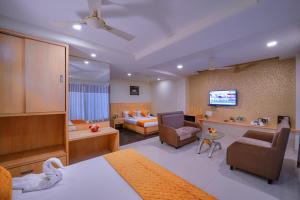a hotel room with a bed and a living room at Wingston A TreeHouse Hotel, Goverdhan in Govardhan