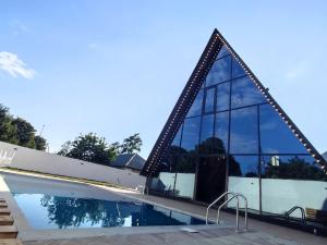 a house with a swimming pool with mirrored windows at Dreamsville Chalet Gabala in Gabala