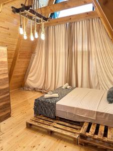 a bedroom with a bed on a wooden platform at Dreamsville Chalet Gabala in Gabala