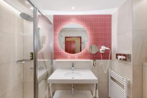 a bathroom with a sink and a mirror at Austria Classic Hotel Wien in Vienna