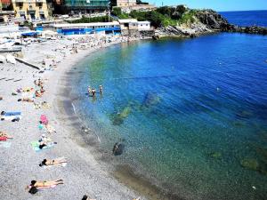 a group of people on a beach in the water at AC Hotel Genova by Marriott in Genoa