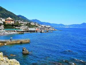 a view of a body of water with houses and buildings at AC Hotel Genova by Marriott in Genoa