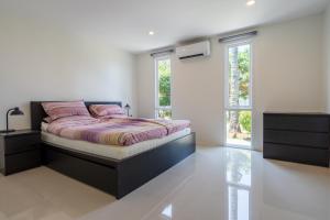 a bedroom with a bed and a large window at Exclusive beach apartment with Wonderful View in Ko Lanta +16 photos