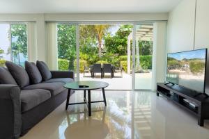 a living room with a couch and a table at Exclusive beach apartment with Wonderful View in Ko Lanta