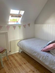 a bedroom with a bed and a window at Grovehouse in Portstewart