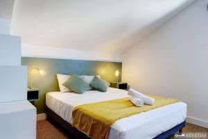 a bedroom with a large white bed with a yellow blanket at Villa Haven - Piscine - Grand-Bois in Saint-Pierre +20 photos