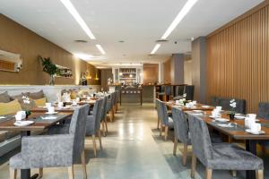 a dining room with wooden tables and chairs at Nuss Buenos Aires Soho in Buenos Aires