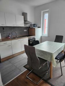a kitchen with a table and chairs in a room at Monteurwohnungen Lerbachtal in Osterode