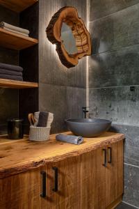 a bathroom with a sink on a wooden counter at Apartmán Bedřich VI. in Bedřichov +28 photos
