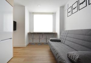 a living room with a couch and a table at Apartamentos Xiana in O Grove