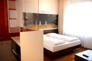 A bed or beds in a room at arte Hotel Linz
