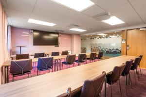 a large conference room with a large table and chairs at Quality Hotel The Mill in Malm&ouml;