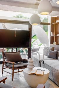 a living room with a large tv and a couch at Zen Vama Veche in Vama Veche