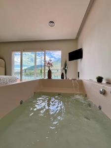 a large bath tub filled with water in a room at Villa Giulietta lake view Jacuzzi Spa 108 in Blevio +47 photos