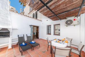 a living room with a table and chairs and a fireplace at Pueblo Evita Premium Suites in Benalmádena
