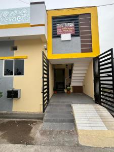 a yellow building with a door with a sign on it at Dream Ashoka Homestay in Ujjain