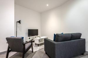 a living room with a couch and a tv at Budget 1 Bed Flat in Central Doncaster in Doncaster