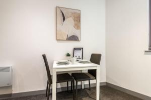 a white table with two chairs and a table and a picture at Budget 1 Bed Flat in Central Doncaster in Doncaster