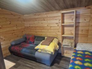 a log cabin with a bed and a bunk bed at Domek GLAMPING na Polu namiotowym RADOŚĆ in Okuninka