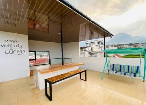 a room with a bench and a bed at Lunara Villa in Batu