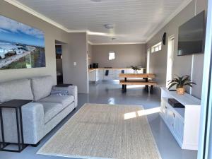 a living room with a couch and a table at Mya in Agulhas