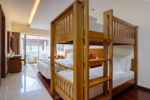 two bunk beds in a room with a bedroom at MERUSAKA Nusa Dua in Nusa Dua
