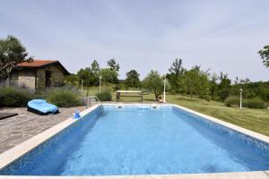 a large swimming pool in a yard with a house at Vila Vesna in Grožnjan