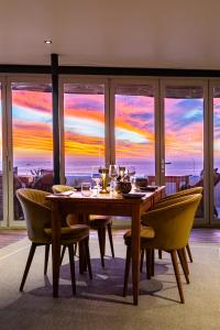 a dining room with a table and chairs with a view at Abalone Hotel & Villas in Paternoster +161 photos