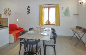 a dining table and chairs in a living room at Lovely Home In Bessas in Bessas