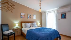 a bedroom with a blue bed and a chair at Alojamento Armando Monteiro in Folgosa