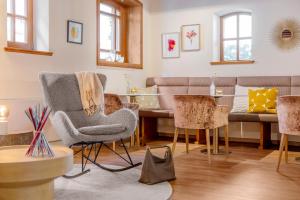 a living room with chairs and a couch at Tides Boutique Hotel in Norden