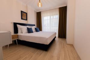 Postel nebo postele na pokoji v ubytování Kamer Exclusive Hotel & Suites