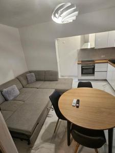 a living room with a couch and a table at Apartman Bruna in Split +3 photos