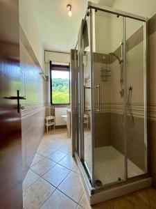 a bathroom with a shower with a glass shower stall at Kibilu - Cittiglio vicinanze Ospedale, Lago Maggiore in Cittiglio +22 photos