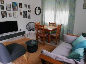 a living room with a couch and a table at Giannis house in Makri