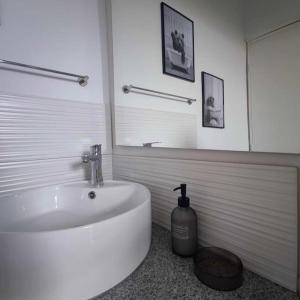 a bathroom with a white sink and a mirror at Giannis house in Makri +13 photos