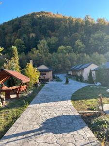 a stone walkway with a mountain in the background at Casa Ardeleanului in Piatra Neamţ