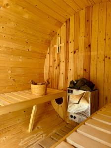 a wooden sauna with a bench and a microwave at Ganzes Tiny House "Thüringer Ruhe" mit großem Garten nahe Rennsteig in Laucha +16 photos