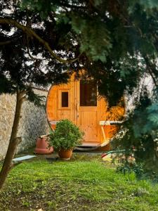 a wooden door of a house with a potted plant at Ganzes Tiny House "Thüringer Ruhe" mit großem Garten nahe Rennsteig in Laucha