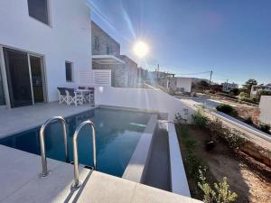 a swimming pool on the side of a building at Aetheria Apartment with Private Pool in Kampos Paros