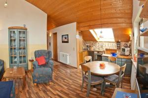 a living room with a table and a kitchen at Ferienwohnung Promenadenweg Nesselwang 14-8 in Nesselwang +6 photos