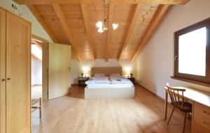 une chambre avec un lit et un plafond en bois dans l'établissement Cozy Home In Lamon With Wifi, à Lamon