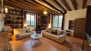 a living room with two couches and a table at Gîte Hurlevent in Azay-le-Rideau