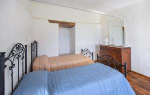 a bedroom with a bed and a dresser and a mirror at 1 Bedroom Cozy Home In Longobardi in Longobardi +5 photos