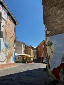 a mural of a woman on the side of a building at Casetta Sant'Angelo in SantʼAngelo +2 photos