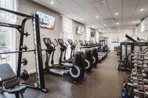 a gym with rows of treadmills and machines at Greenwoods Hotel & Spa in Stock